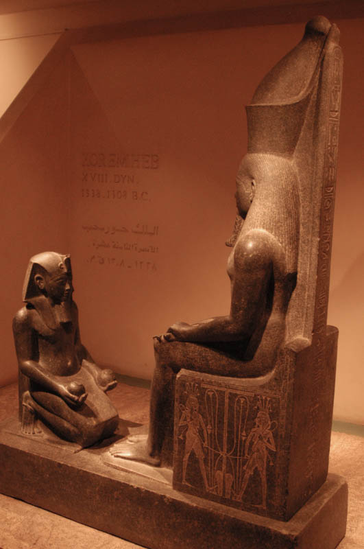 Seated statue of a goddess, with a kneeling acolyte