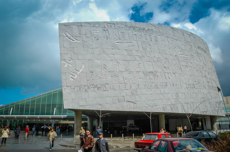 The curving facade of the library, covered in symbols