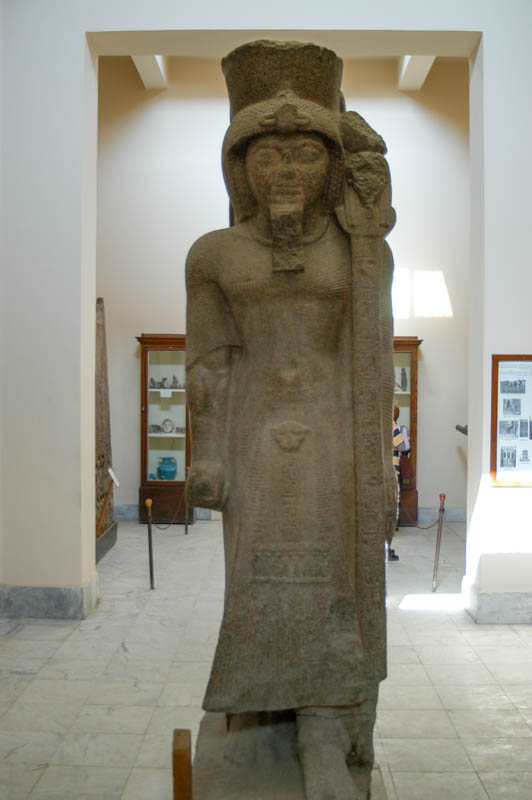 a female figure, dressed as a greek, posed as an egyptian