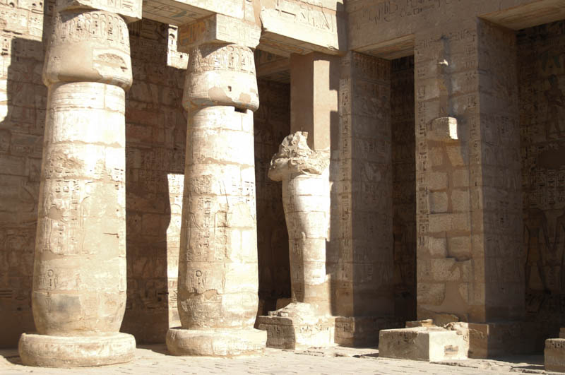 Columns and mummiform statues along the courtyard wall