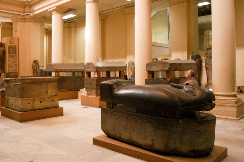 Rows and rows of stone sarcophagi in the museum