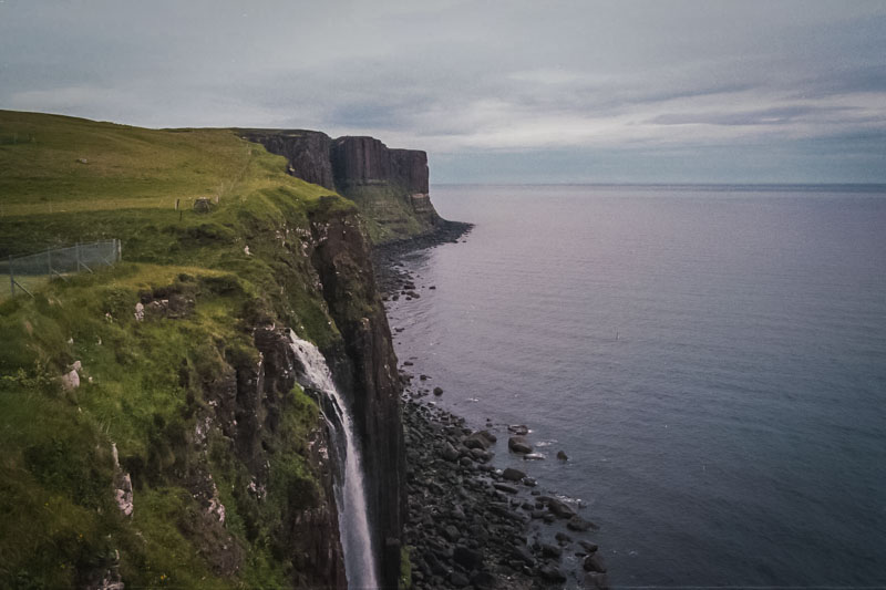 Waterfall over the edge of the green cliffs